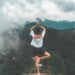 Girl on a mountain in Yoga tree pose
