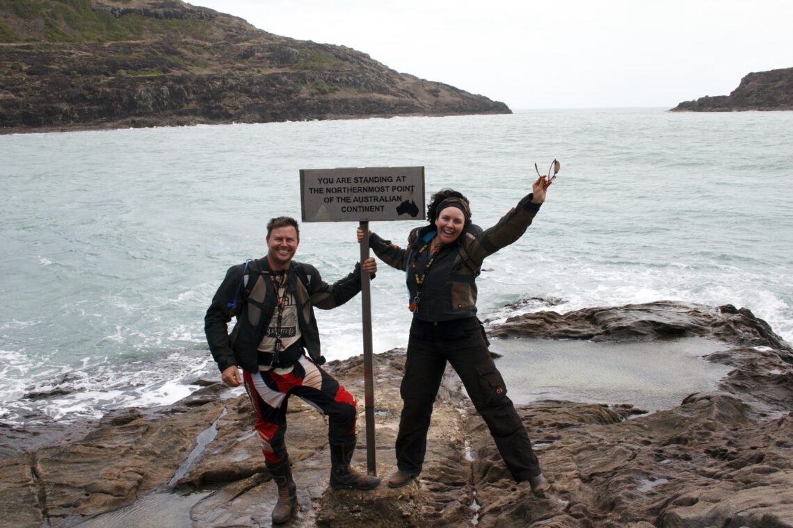Two people standing at the Top of Australia sign at Cape York