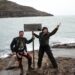 Two people standing at the Top of Australia sign at Cape York