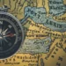 compass on an antique map of the world