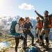 people on summiting a peak with mountain views and celebrating